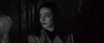 Movie still from “Werewolf by Night” (2022), directed by Michael Giacchino – A black and white photo of a woman with long dark hair; Close Up shot, High angle