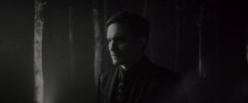 Movie still from “Werewolf by Night” (2022), directed by Michael Giacchino – A black and white photo of a man wearing a suit and tie; Close Up shot, Low angle