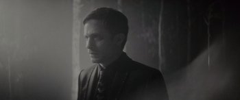 Movie still from “Werewolf by Night” (2022), directed by Michael Giacchino – A black and white photo of a man in a suit; Close Up shot, Over the shoulder angle