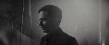 Movie still from “Werewolf by Night” (2022), directed by Michael Giacchino – A black and white photo of a man in a suit; Close Up shot, Low angle