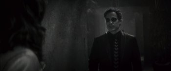 Movie still from “Werewolf by Night” (2022), directed by Michael Giacchino – A black and white photo of a man in a suit; Close Up shot, Over the shoulder angle