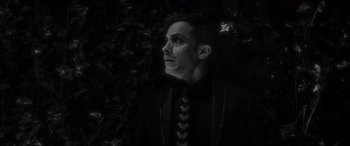 Movie still from “Werewolf by Night” (2022), directed by Michael Giacchino – A black and white photo of a man looking up; Close Up shot, Low angle