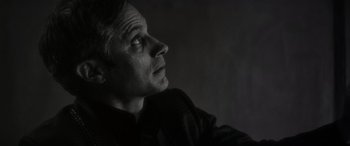 Movie still from “Werewolf by Night” (2022), directed by Michael Giacchino – A black and white photo of a man looking up at the sky; Close Up shot, Low angle