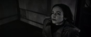 Movie still from “Werewolf by Night” (2022), directed by Michael Giacchino – A black and white photo of a woman looking at the camera; Close Up shot, High angle