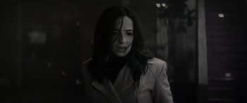 Movie still from “Werewolf by Night” (2022), directed by Michael Giacchino – A black and white photo of a woman with long dark hair; Close Up shot, Low angle