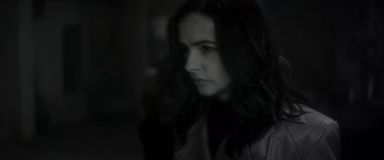 Movie still from “Werewolf by Night” (2022), directed by Michael Giacchino – A black and white photo of a woman with long dark hair; Close Up shot, Over the shoulder angle