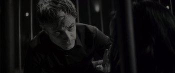 Movie still from “Werewolf by Night” (2022), directed by Michael Giacchino – A black - and - white photo of a man in a black shirt; Close Up shot, Over the shoulder angle