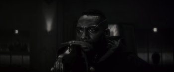 Movie still from “Werewolf by Night” (2022), directed by Michael Giacchino – A black and white photo of a man with a snake in his mouth; Close Up shot, Over the shoulder angle