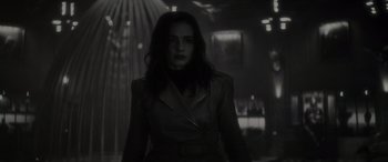 Movie still from “Werewolf by Night” (2022), directed by Michael Giacchino – A black and white photo of a woman in a suit; Medium shot, Low angle