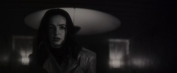 Movie still from “Werewolf by Night” (2022), directed by Michael Giacchino – A black and white photo of a woman in a leather jacket; Close Up shot, Low angle