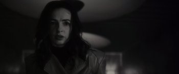 Movie still from “Werewolf by Night” (2022), directed by Michael Giacchino – A black and white photo of a woman in a hat; Close Up shot, Low angle