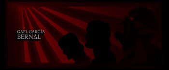 Movie still from “Werewolf by Night” (2022), directed by Michael Giacchino – A group of people that are silhouetted against a red background; Extreme Close Up shot, Low angle