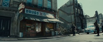 Movie still from “West Side Story” (2021), directed by Steven Spielberg – A building that has been destroyed in a city; Extreme Wide shot, Over the shoulder angle