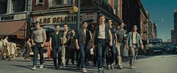 Movie still from “West Side Story” (2021), directed by Steven Spielberg – A group of young men walking down a street; Wide shot, High angle
