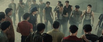 Movie still from “West Side Story” (2021), directed by Steven Spielberg – A group of men standing in the middle of a street; Medium shot, Over the shoulder angle
