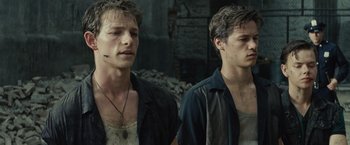 Movie still from “West Side Story” (2021), directed by Steven Spielberg – A man in a black shirt is looking at his reflection in a mirror; Close Up shot, Low angle