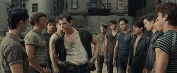 Movie still from “West Side Story” (2021), directed by Steven Spielberg – A group of young men standing next to each other; Medium shot, High angle