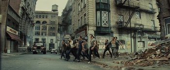Movie still from “West Side Story” (2021), directed by Steven Spielberg – A group of young men walking down a street; Wide shot, High angle