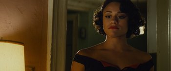 Movie still from “West Side Story” (2021), directed by Steven Spielberg – A woman in a black and red dress looking at the camera; Close Up shot, Low angle