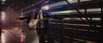 Movie still from “West Side Story” (2021), directed by Steven Spielberg – A man and a woman are standing next to each other; Medium shot, Low angle