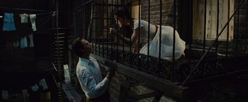 Movie still from “West Side Story” (2021), directed by Steven Spielberg – A man and a woman on a staircase; Medium shot, Low angle