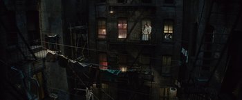 Movie still from “West Side Story” (2021), directed by Steven Spielberg – A building with many windows on the side of the building; Extreme Wide shot, Overhead angle