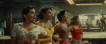 Movie still from “West Side Story” (2021), directed by Steven Spielberg – A group of women standing next to each other; Medium shot, High angle
