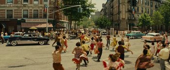 Movie still from “West Side Story” (2021), directed by Steven Spielberg – A group of people on the street dancing; Extreme Wide shot, High angle
