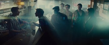 Movie still from “West Side Story” (2021), directed by Steven Spielberg – A group of people standing around a room; Medium shot, Over the shoulder angle