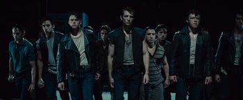 Movie still from “West Side Story” (2021), directed by Steven Spielberg – A group of young men standing next to each other; Medium shot, Low angle