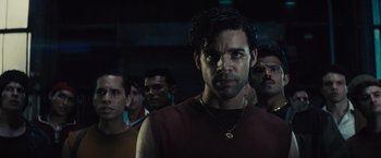 Movie still from “West Side Story” (2021), directed by Steven Spielberg – A group of men standing next to each other in a dark room; Close Up shot, Low angle