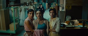 Movie still from “West Side Story” (2021), directed by Steven Spielberg – A group of women standing next to each other in a room; Medium shot, Low angle
