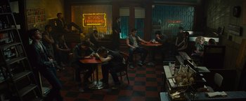 Movie still from “West Side Story” (2021), directed by Steven Spielberg – A group of people sitting at tables in a restaurant; Wide shot, High angle