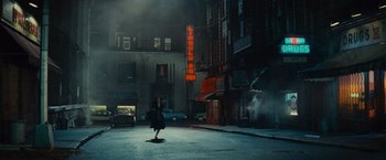 Movie still from “West Side Story” (2021), directed by Steven Spielberg – A woman walking down the street at night; Extreme Wide shot, Low angle