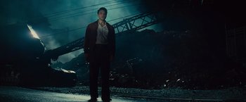 Movie still from “West Side Story” (2021), directed by Steven Spielberg – A man standing in front of a pile of rubble; Wide shot, Low angle