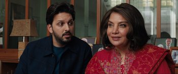 Movie still from “What's Love Got to Do with It?” (2022), directed by Shekhar Kapur – A man and a woman sitting next to each other; Close Up shot, Over the shoulder angle