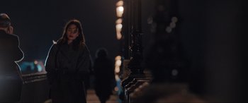 Movie still from “What's Love Got to Do with It?” (2022), directed by Shekhar Kapur – A woman standing next to a street light at night; Medium shot, Over the shoulder angle