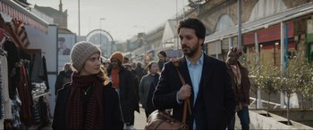 Movie still from “What's Love Got to Do with It?” (2022), directed by Shekhar Kapur – A crowd of people walking down a street; Close Up shot, Over the shoulder angle