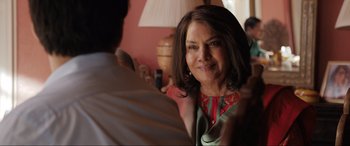 Movie still from “What's Love Got to Do with It?” (2022), directed by Shekhar Kapur – A person standing next to another person; Close Up shot, Over the shoulder angle