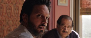 Movie still from “What's Love Got to Do with It?” (2022), directed by Shekhar Kapur – A person with a beard; Close Up shot, Over the shoulder angle