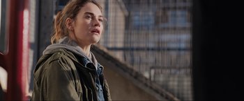 Movie still from “What's Love Got to Do with It?” (2022), directed by Shekhar Kapur – A young woman is standing in front of a building; Close Up shot, Over the shoulder angle