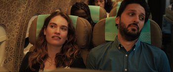 Movie still from “What's Love Got to Do with It?” (2022), directed by Shekhar Kapur – A woman sitting next to a man on a bus; Close Up shot, Over the shoulder angle
