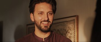 Movie still from “What's Love Got to Do with It?” (2022), directed by Shekhar Kapur – A person wearing a maroon shirt; Close Up shot, Low angle