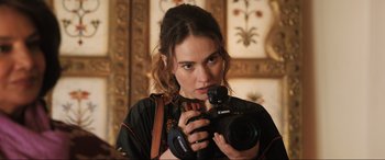 Movie still from “What's Love Got to Do with It?” (2022), directed by Shekhar Kapur – A woman holding a camera in front of a mirror; Close Up shot, Over the shoulder angle