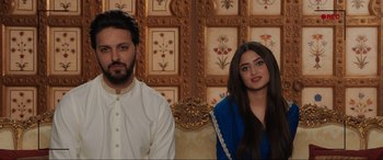 Movie still from “What's Love Got to Do with It?” (2022), directed by Shekhar Kapur – A man and a woman sitting next to each other; Medium shot, Low angle