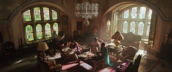 Movie still from “What's Love Got to Do with It?” (2022), directed by Shekhar Kapur – A group of people sitting in a living room; Wide shot, High angle