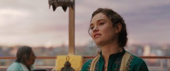 Movie still from “What's Love Got to Do with It?” (2022), directed by Shekhar Kapur – A beautiful young lady wearing a green dress; Close Up shot, Over the shoulder angle