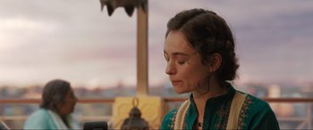 Movie still from “What's Love Got to Do with It?” (2022), directed by Shekhar Kapur – A woman in a green shirt is looking down; Close Up shot, Over the shoulder angle