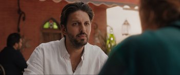 Movie still from “What's Love Got to Do with It?” (2022), directed by Shekhar Kapur – A person wearing a white shirt; Close Up shot, Over the shoulder angle