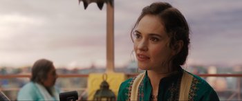 Movie still from “What's Love Got to Do with It?” (2022), directed by Shekhar Kapur – A beautiful young lady wearing a green dress; Close Up shot, Over the shoulder angle